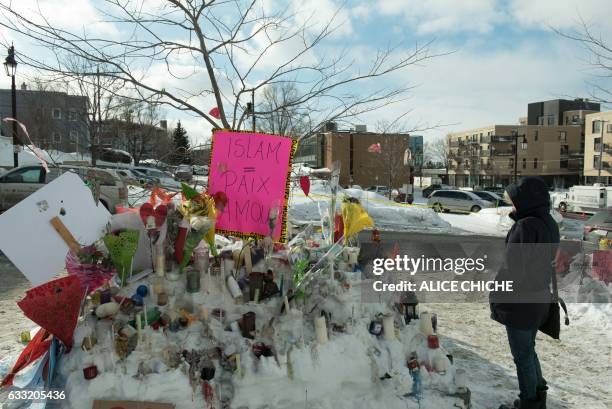 People place messages and flowers near a mosque that was the location of a shooting spree in Quebec City, Quebec on January 31, 2017. Alexandre...