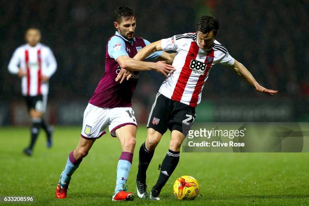 Lasse Vibe of Brentford is challenged by Conor Hourihane of Aston Villa during the Sky Bet Championship match between Brentford and Aston Villa at...