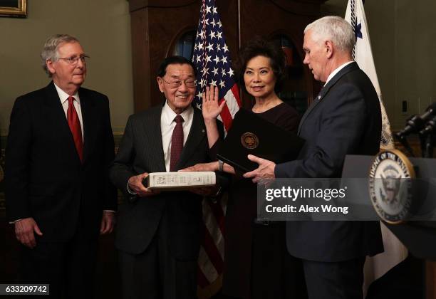 Elaine Chao is sworn in by U.S. Vice President Mike Pence as her father James Chao and her husband Senate Majority Leader Sen. Mitch McConnell look...