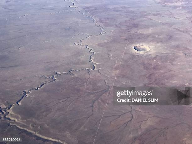 The Meteor Crater near Winslow, Arizona, is seen from a plane Januray 30, 2017. The nearby Meteor Crater, sometimes known as the Barringer Crater and...