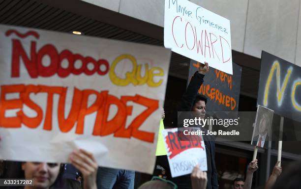 Protesters gather against Miami-Dade Mayor Carlos Gimenez's decision to abide by President Donald Trump's order to effectively abandon the county's...