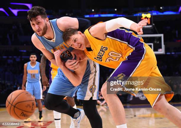 Timofey Mozgov of the Los Angeles Lakers and Jusuf Nurkic of the Denver Nuggets chase down a rebound in the first half of the game at Staples Center...