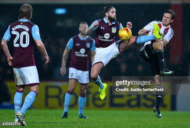 Henri Lansbury of Aston Villa and Lasse Vibe of Brentford FC during the Sky Bet Championship match between Brentford and Aston Villa at Griffin Park...