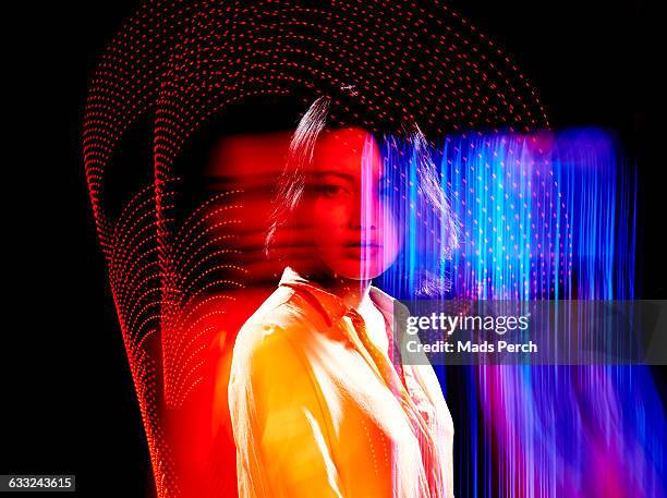 female model surrounded by colorful lights - yellow blouse stockfoto's en -beelden