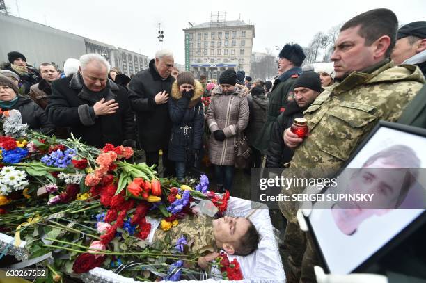 Relatives of one of the seven Ukrainian servicemen who died during fighting in eastern Ukrainian town of Avdiivka, in Donetsk region, react next to...