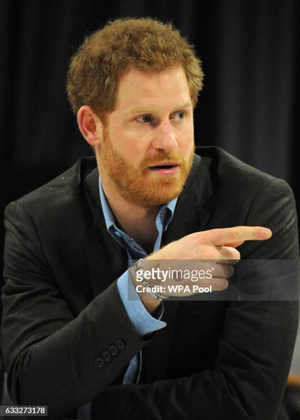 Prince Harry gestures during a meeting with teachers and tutors during a visit to the Full Effect and Coach Core programmes at Nottingham Academy on...