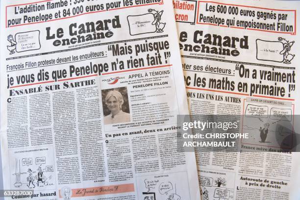 This picture taken on February 1, 2017 in Paris shows the front pages dated January 25, 2017 and February 1, 2017 of French satirical newspaper "Le...