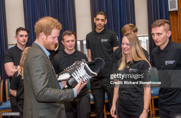 Prince Harry Receives a pair of Ice Skates signed by the graduats of Coach Core during an official visit to Full Effect & Coach Core on February 1,...