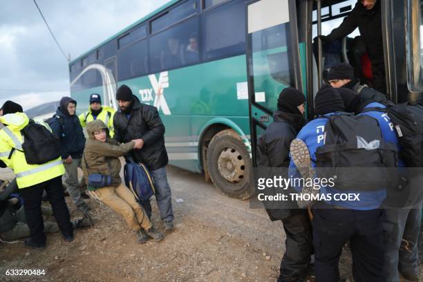 Israeli security forces carry teenage Jewish settlers towards a bus as they evict settlers from the wildcat Amona outpost, northeast of Ramallah, on...