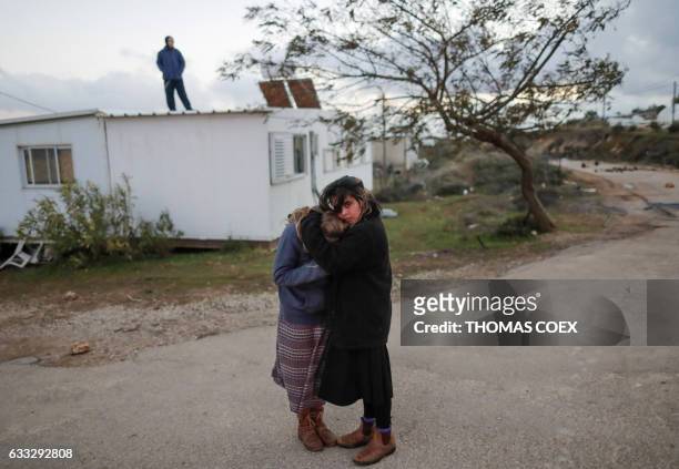 Two young Jewish settlers embrace as Israeli security forces evict hardline residents from the wildcat Amona outpost, northeast of Ramallah, on...