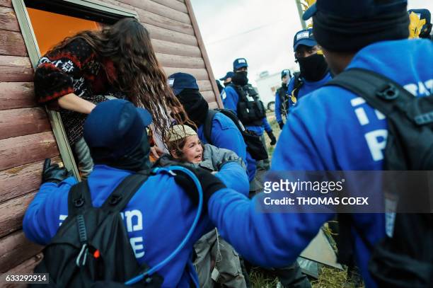 Child cries as Israeli security forces evict Jewish hardline residents from the wildcat Amona outpost, northeast of Ramallah, on February 1 in line...