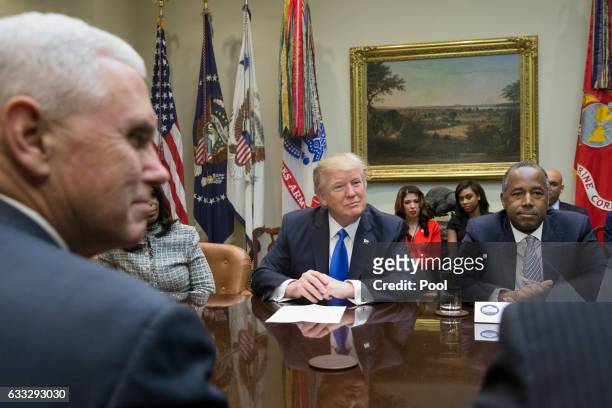 President Donald Trump , US Vice President Mike Pence and Trump's nominee to lead the Department of Housing and Urban Development Ben Carson attend...