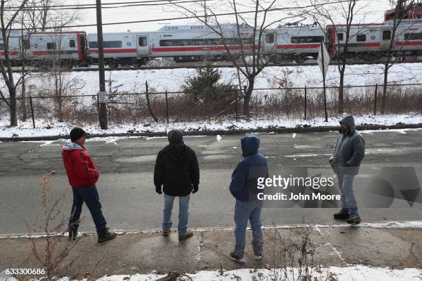 Immigrants wait for work in a day labor pick-up zone on February 1, 2017 in Stamford, Connecticut. The city of Stamford has an official area for...