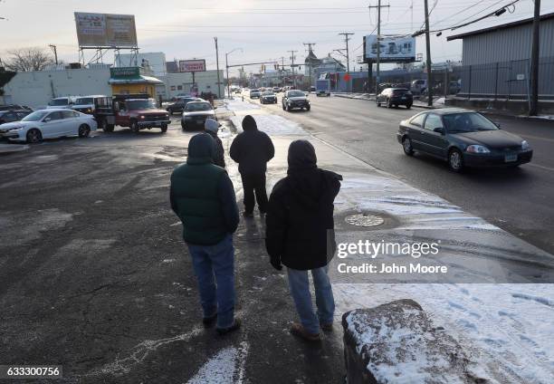 Undocumented immigrants wait for work along a city street on February 1, 2017 in Stamford, Connecticut. The city of Stamford has an official zone for...