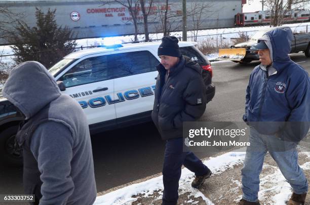 Police move immigrants towards an official day labor pick-up site on February 1, 2017 in Stamford, Connecticut. The city of Stamford has an official...