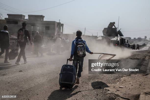 Civilians from the Gogjali, Saddam and Samah districts of Mosul flee their homes as members of Iraqi Special Operations Forces enter Mosul to retake...