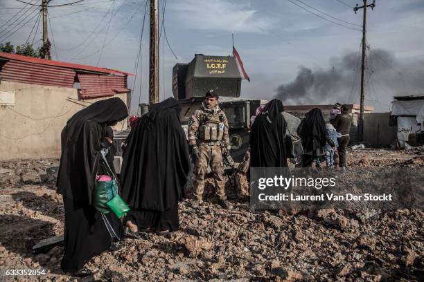 Civilians in Mosul flee their homes as members of Iraqi Special Operations Forces enter Mosul to retake the city from the Islamic State. The...