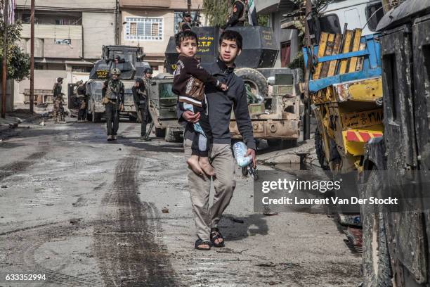 Civilians in Mosul flee their homes as members of Iraqi Special Operations Forces enter Mosul to retake the city from the Islamic State. The...