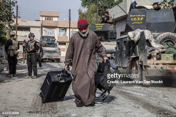 Civilians in Mosul flee their homes as members of Iraqi Special Operations Forces enter Mosul to retake the city from the Islamic State. The...