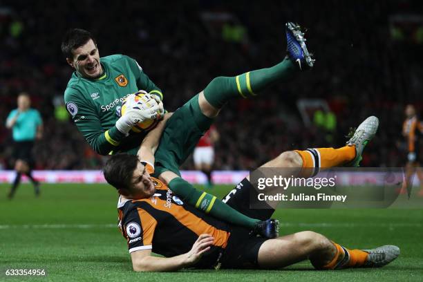 Eldin Jakupovic of Hull City clashes with Harry Maguire of Hull City during the Premier League match between Manchester United and Hull City at Old...