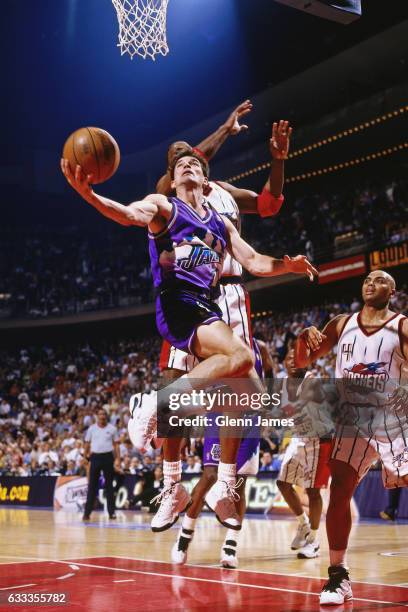 John Stockton of the Utah Jazz shoots against the Houston Rockets during Game Three of the Western Conference Finals on May 23, 1997 at the Summit in...