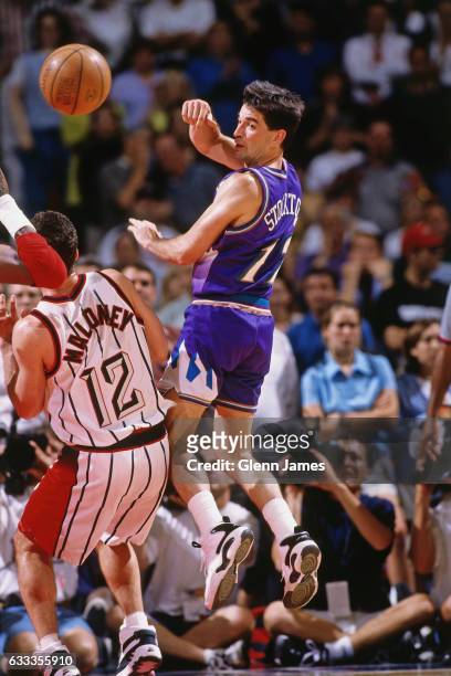John Stockton of the Utah Jazz passes against the Houston Rockets during Game Three of the Western Conference Finals on May 23, 1997 at the Summit in...