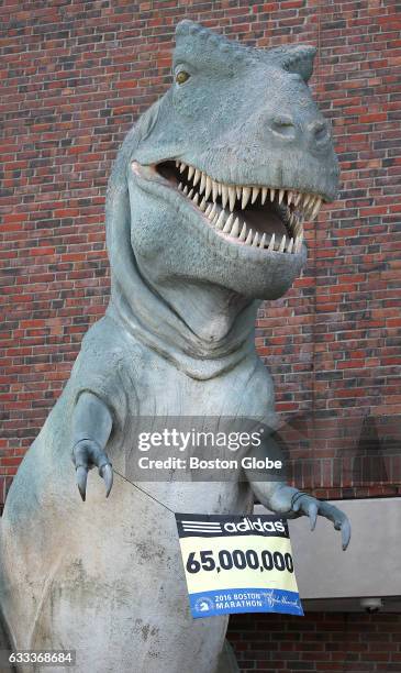 Tyrannosaurus statue in front of the Museum of Science in Boston holds up a Boston Marathon sign on Apr. 18, 2016.