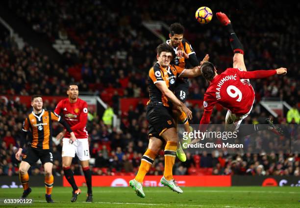 Zlatan Ibrahimovic of Manchester United performs an acrobatic kick with Harry Maguire and Andrea Ranocchia of Hull City during the Premier League...