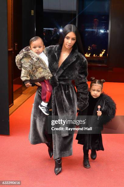 Saint West, television personality Kim Kardashian West and North West leave their Midtown Manhattan hotel on February 1, 2017 in New York City.