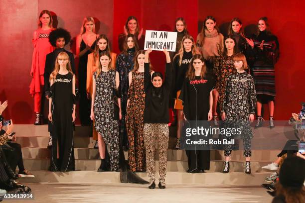 Leyla Piedayesh holds a sign saying 'I'm an Immigrant' at the end of her Lala Berlin show during the Copenhagen Fashion Week Autumn/Winter 17 on...