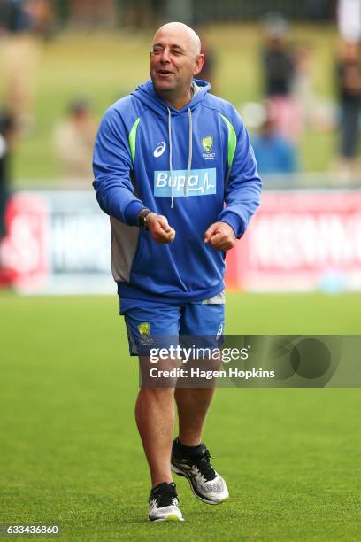 Coach Darren Lehmann of Australia enjoys a laugh as rain delays play during game two of the One Day International series between New Zealand and...