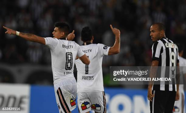 Chile's Colo-Colo player Esteban Paredes celebrates with teammate Esteban Pavez after scoring a goal against Brazil's Botafogo during their Copa...