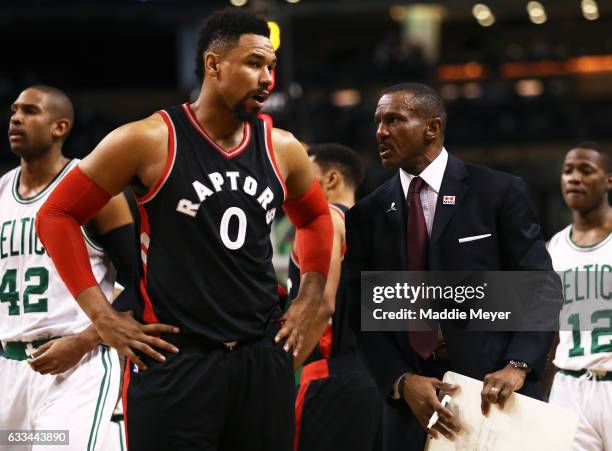Jared Sullinger of the Toronto Raptors talks with Head Coach Dwane Casey during the second quarter against the Boston Celtics at TD Garden on...
