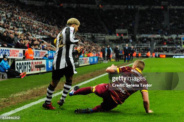 Jake Bidwell of Queens Park Rangers makes a sliding tackle on DeAndre Yedlin of Newcastle United during the Sky Bet Championship match between...