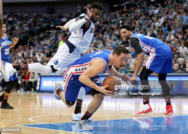 McConnell of the Philadelphia 76ers dribbles the ball against Wesley Matthews of the Dallas Mavericks in the first half at American Airlines Center...