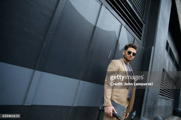 Guest is seen wearing a brown suit paired witha gray T-shirt outisde the Nautica fashion show during New York Men's Fashion Week AW17 on February 1,...