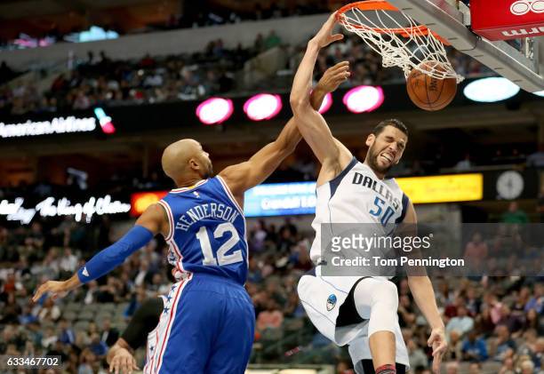 Salah Mejri of the Dallas Mavericks dunks against Gerald Henderson of the Philadelphia 76ers in the second half at American Airlines Center on...