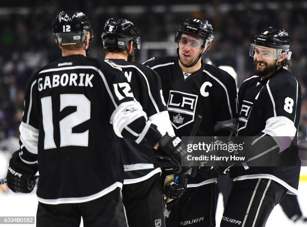 Anze Kopitar of the Los Angeles Kings laughs with Drew Doughty, Dustin Brown and Marian Gaborik with a 5-0 lead over the Colorado Avalanche during...