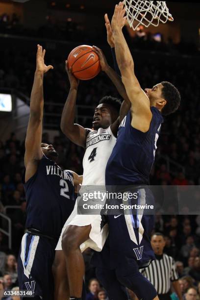 Providence Friars guard Maliek White drives to the basket against Villanova Wildcats forward Kris Jenkins and Villanova Wildcats guard Josh Hart...