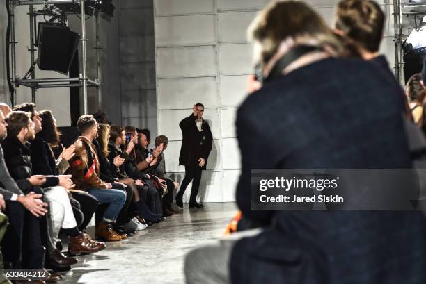 Raf Simons greets the audience at the Raf Simons show during NYFW: Men's on February 1, 2017 in New York City.