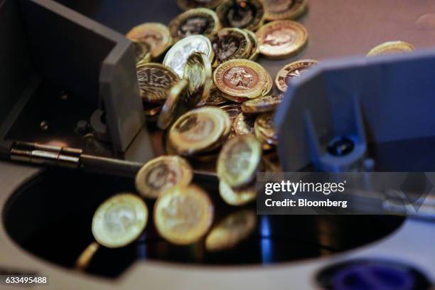 Machine weighs and counts samples of coins at the opening of the Trial of the Pyx at Goldsmiths' Hall in London, U.K., on Tuesday, Jan. 31, 2017. In...