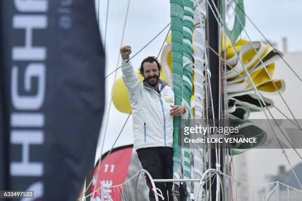 French skipper Louis Burton celebrates aboard his Imoca monohull "Bureau Vallee" as he arrives in Les Sables-d'Olonne, western France, after placing...