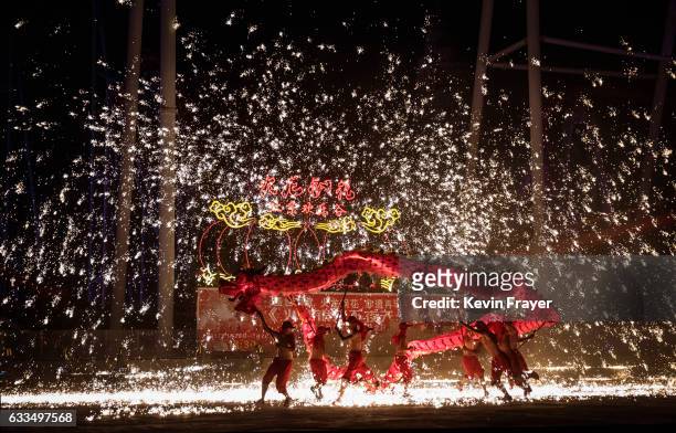 Sparks fly as Chinese dragon dancers perform at a fair at a local park on the fifth day of the Chinese Lunar New Year on February 1, 2017 in Beijing,...