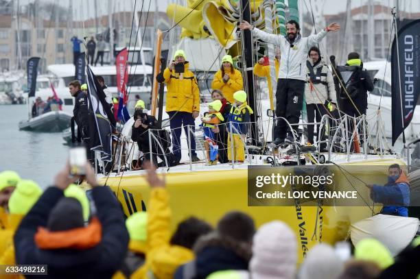 French skipper Louis Burton celebrates aboard his Imoca monohull "Bureau Vallee" after arriving in Les Sables-d'Olonne, western France, to place 7th...