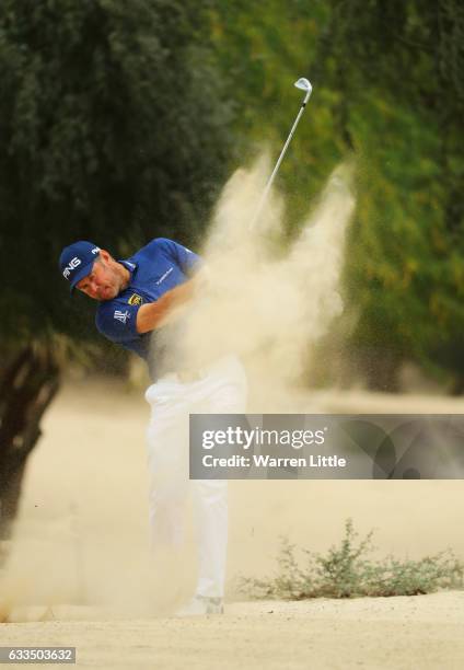 Lee Westwood of England plays his second shot on the 14th hole during the first round of the Omega Dubai Desert Classic at Emirates Golf Club on...