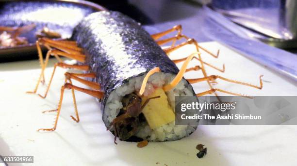 The special bug-filled festive "ehomaki" sushi roll produced by the "izakaya" Japanese-style pub Kome to Circus contains grasshoppers, silkworms and...