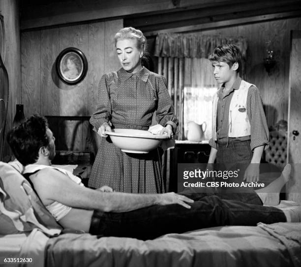 Dick Powells Zane Grey Theater production of the episode Rebel Ranger featuring from left: Scott Forbes , Joan Crawford and Don Grady . Image dated...