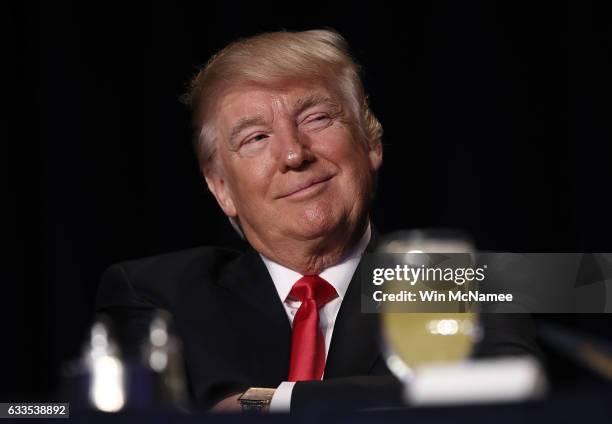 President Donald Trump listens as television producer Mark Burnett introduces him at the National Prayer Breakfast February 2, 2017 in Washington,...