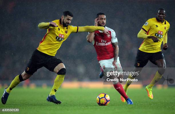 Arsenal's Theo Walcott holds of Watford's Miguel Angel Britos during the Premier League match between Arsenal and Watford at The Emirates , London on...