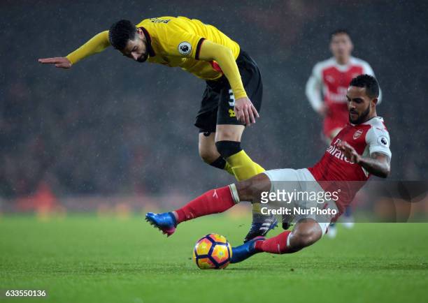 Arsenal's Theo Walcott holds of Watford's Miguel Angel Britos during the Premier League match between Arsenal and Watford at The Emirates , London on...